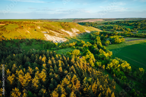 Picturesque summer scene of a rolling hills of rustic area from a bird's eye view.
