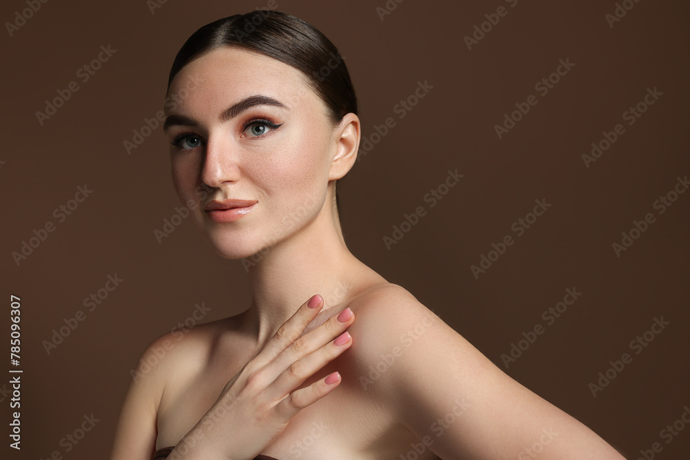 Portrait of beautiful woman with fake freckles on brown background Portrait of beautiful woman with fake freckles on brown background