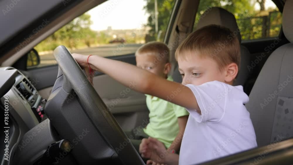 Two little boys are sitting in the car in the front seats, they pretend to be adult drivers. Two little boys are sitting in the car in the front seats, they pretend to be adult drivers.