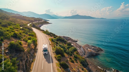 Motorhome adventure along breathtaking coastal road by the sea in summer, aerial view