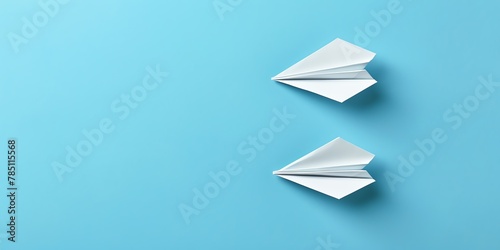 Two paper planes on a blue background.