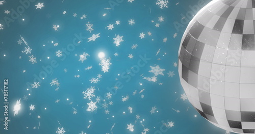 Image of mirror disco ball spinning over snow falling on blue background
