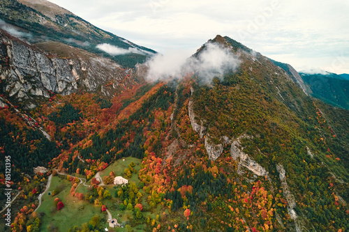 Aerial view of a treecovered mountain with clouds in the sky photo