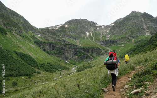 tourists traveler in mountains. rear view. Summer landscape with Hikers trekking in mountains. journey, hiking, adventure concept.