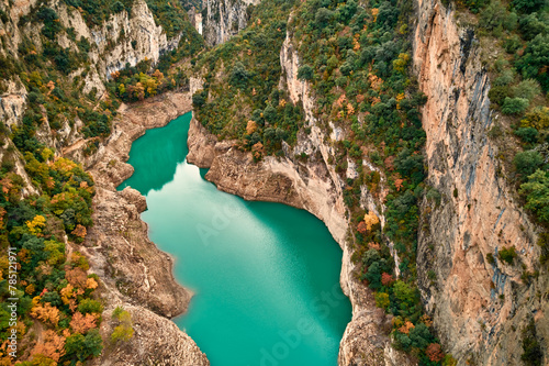 A stunning aerial view of a lake nestled among trees and rocky formations