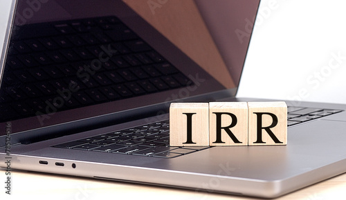 IRR word on wooden block on laptop , business concept