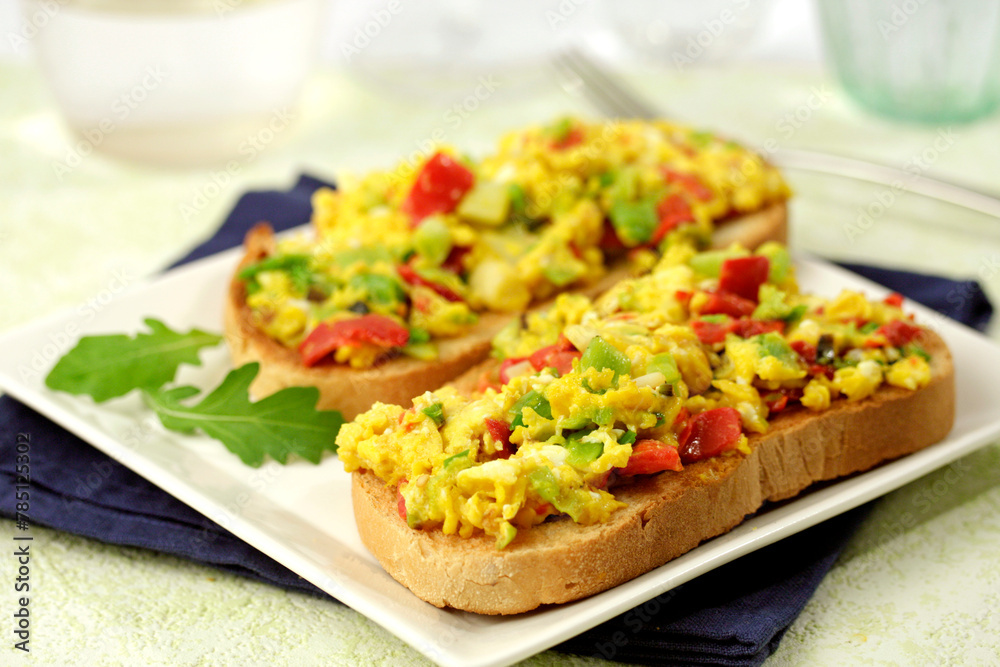 Scrambled eggs on toast with spring garlics. Scrambled eggs on toast with spring garlics.