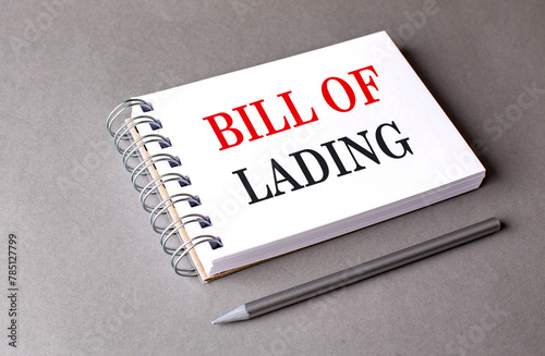 BILL OF LADING text on notebook on grey background photo