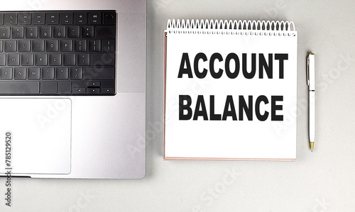 ACCOUNT BALANCE text on notebook with laptop and pen