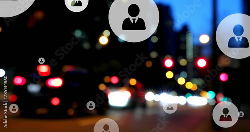 Image of profile icons over blurred vehicles stopped on red signal in street of city