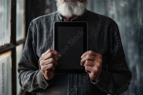 Screen display over shoulder of a middle-aged man holding an ebook with a completely black screen