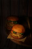 Vertical shot of hamburgers on the wooden background