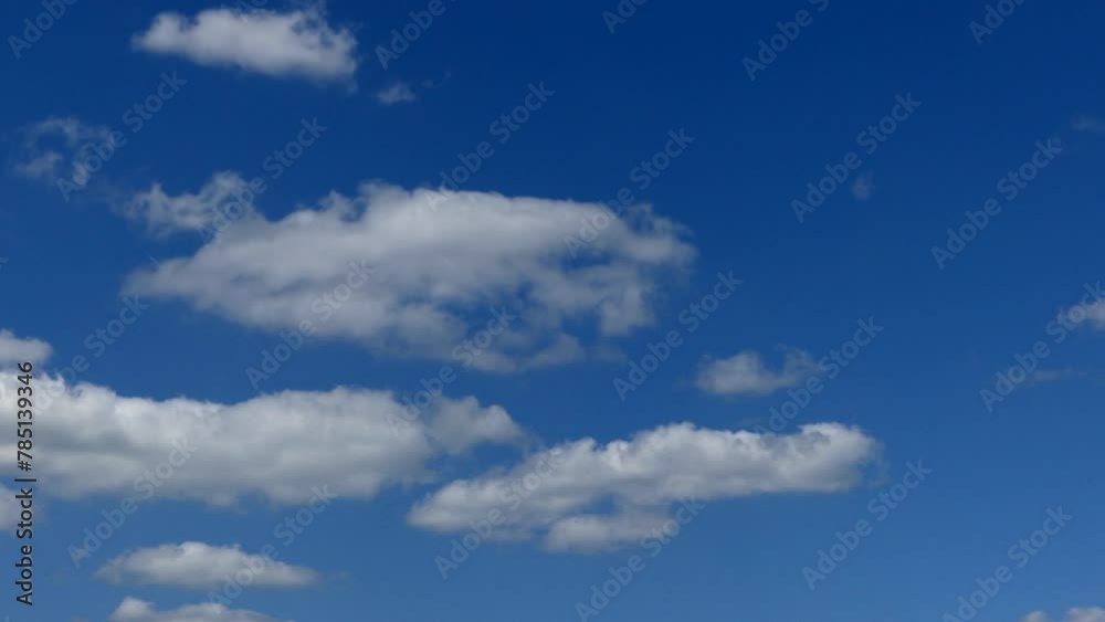 Relaxing time-lapse view of white clouds moving in the blue sky on a sunny day Relaxing time-lapse view of white clouds moving in the blue sky on a sunny day