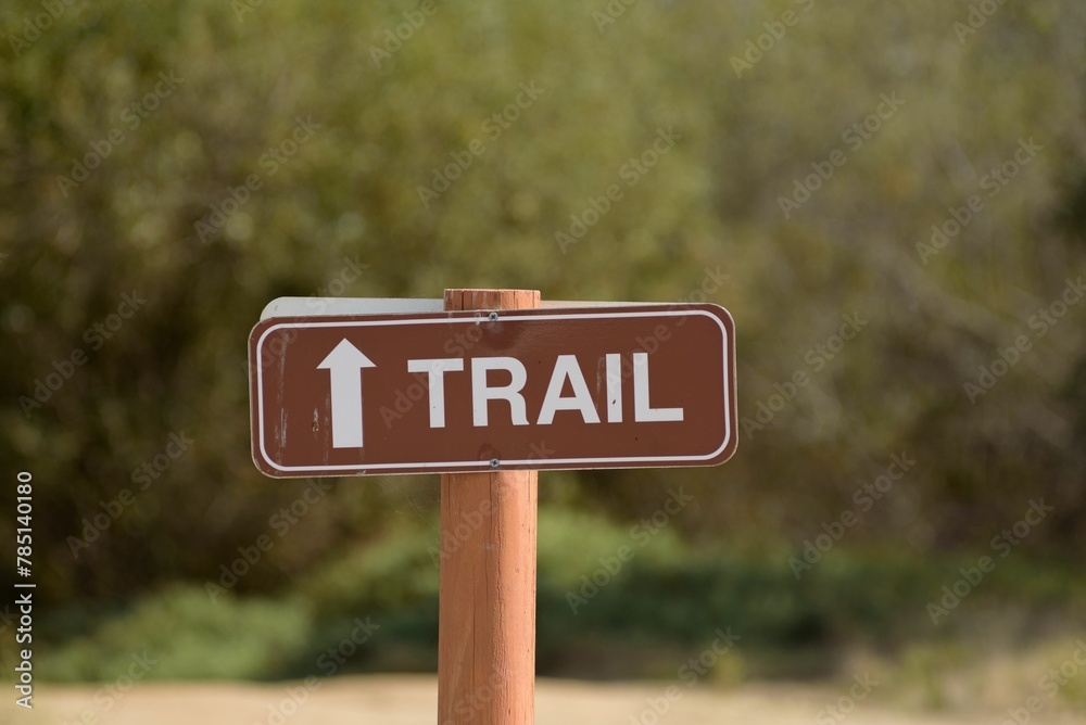 Selective shot of a trail sign, showing the direction in the outdoors, San Diego US