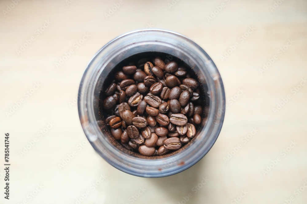 Fototapeta premium Top view of a cup with coffee beans