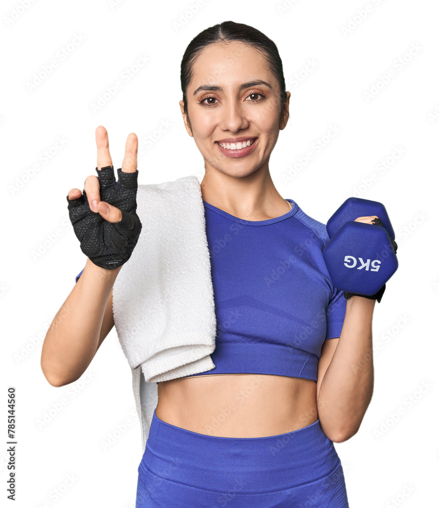 Caucasian young athlete with dumbbell on studio background showing number two with fingers. Caucasian young athlete with dumbbell on studio background showing number two with fingers.