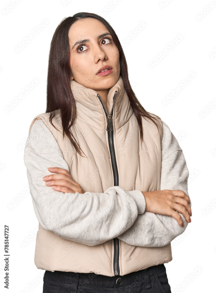 Modern young Caucasian woman portrait on studio background tired of a repetitive task.