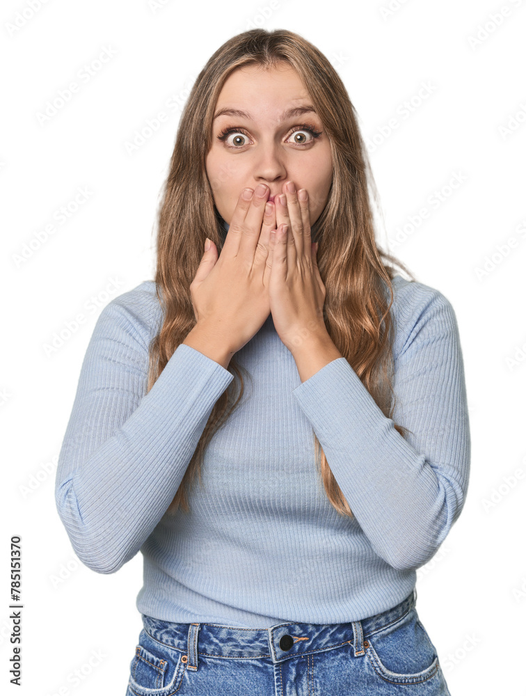 Studio portrait of a blonde Caucasian woman shocked, covering mouth with hands, anxious to discover something new. Studio portrait of a blonde Caucasian woman shocked, covering mouth with hands, anxious to discover something new.