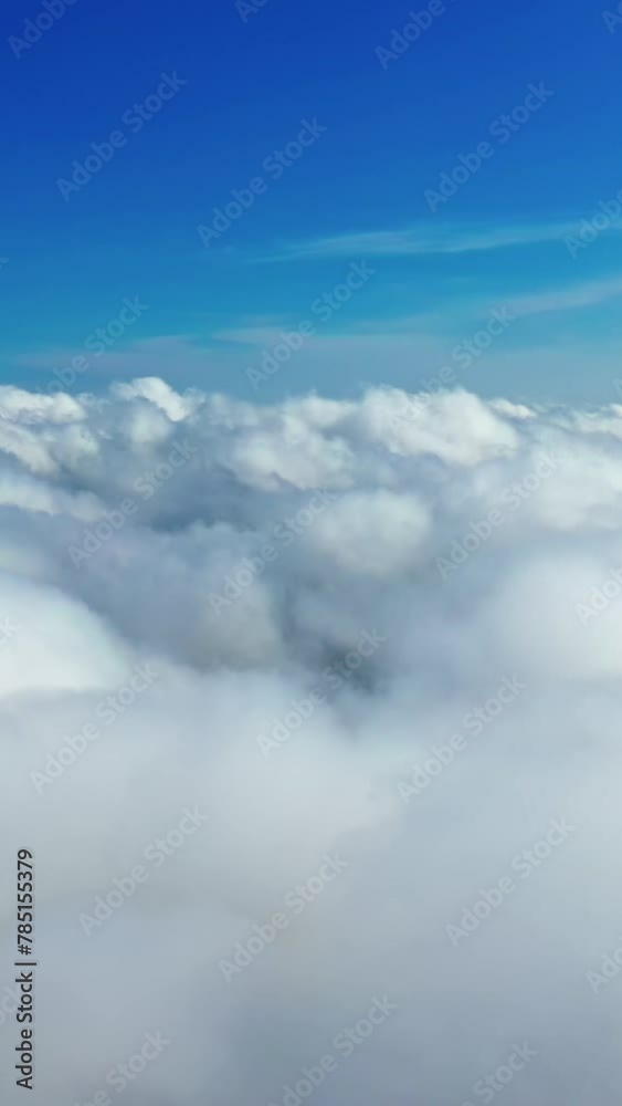 Beautiful white clouds in the air. Panoramic view of blue sky with soft clouds background. Amazing cloudscape. Aerial view. Vertical video Beautiful white clouds in the air. Panoramic view of blue sky with soft clouds background. Amazing cloudscape. Aerial view. Vertical video