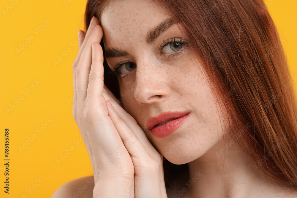 Portrait of beautiful woman with freckles on yellow background, closeup Portrait of beautiful woman with freckles on yellow background, closeup