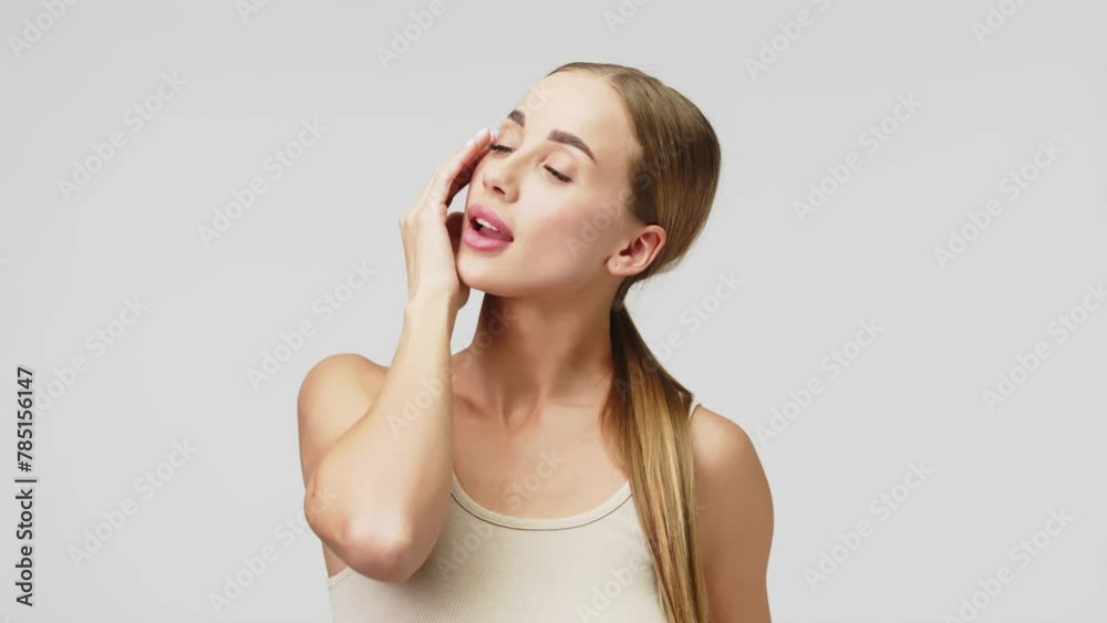 Portrait of a young beautiful woman with smooth healthy skin, she gently touches her face. Cosmetics, spa and skin care products advertising concept. Portrait of a young beautiful woman with smooth healthy skin, she gently touches her face. Cosmetics, spa and skin care products advertising concept.