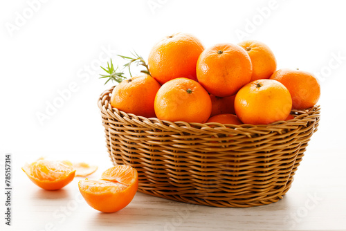 Fresh tangerine orange fruits in wooden basket.