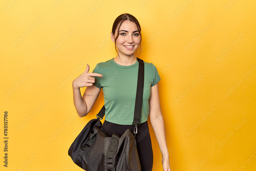 Athletic caucasian woman with sports backpack person pointing by hand to a shirt copy space, proud and confident Athletic caucasian woman with sports backpack person pointing by hand to a shirt copy space, proud and confident