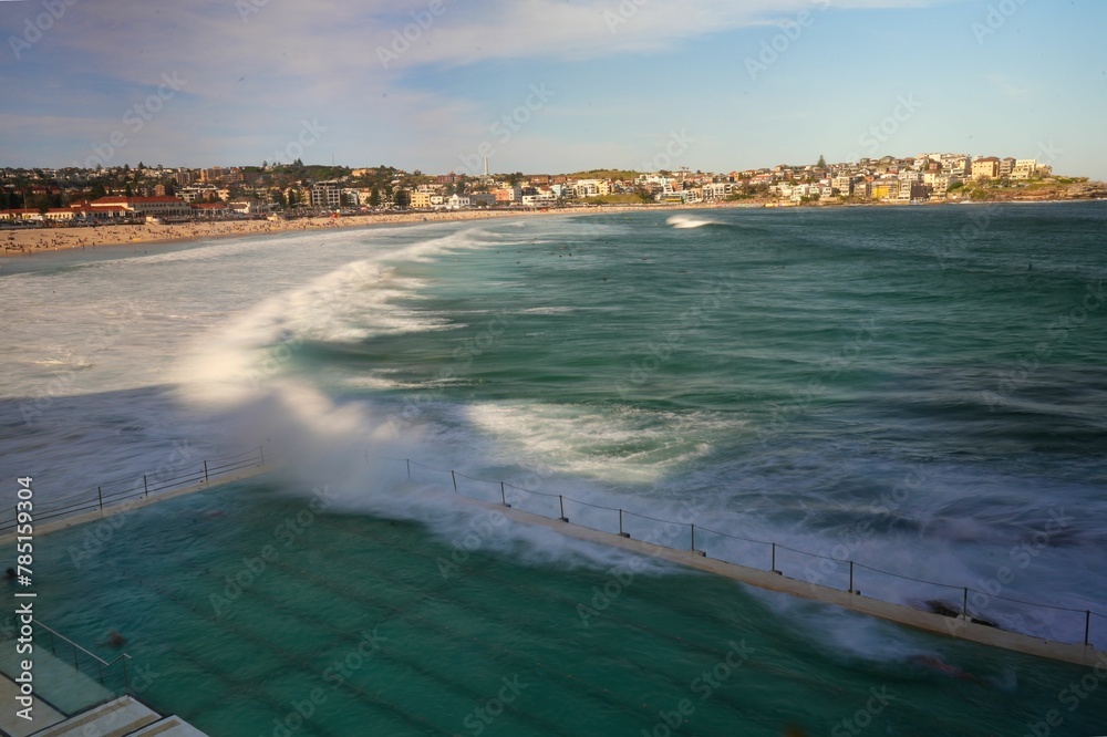 Fototapeta premium Bird's eye view of a pool on the Bondi Beach pool with a background of buildings