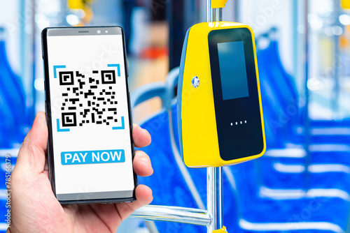 Bus terminal for payment. Phone in man hand. Payment for travel via qr code. Payment terminal on bus handrail. Smartphone with inscription pay now. Passenger hand paying bus fare.