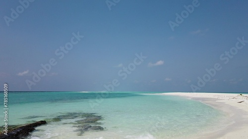 Scenic view of a beautiful sandy beach with turquoise water in The Maldives © Wirestock