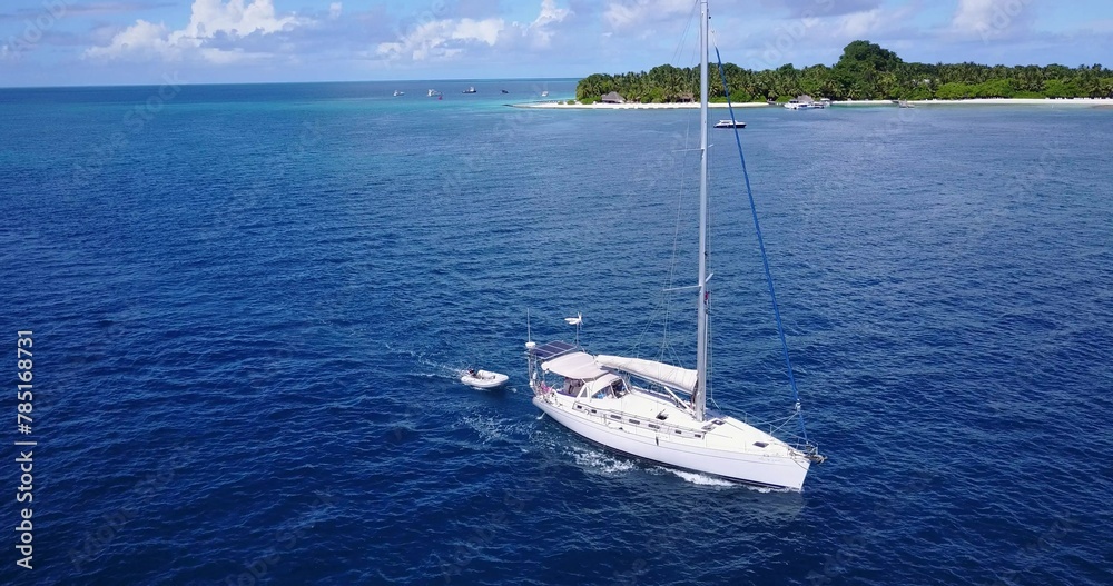 Fototapeta premium Scenic view of boat in the tranquil Indian Ocean near the beautiful beach on a summer day