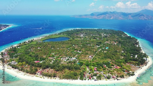 Aerial drone shot of a populated tropical island in Southeast Asia