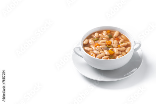 White beans soup with vegetables in white bowl isolated on white background. Copy space photo