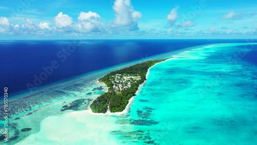Aerial view of lush green tropical island in the middle of the ocean