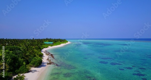 Island covered with green trees surrounded by clean ocean somewhere in Asia © Wirestock