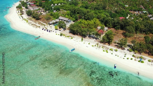 Aerial view of an island with houses and trees by the ocean