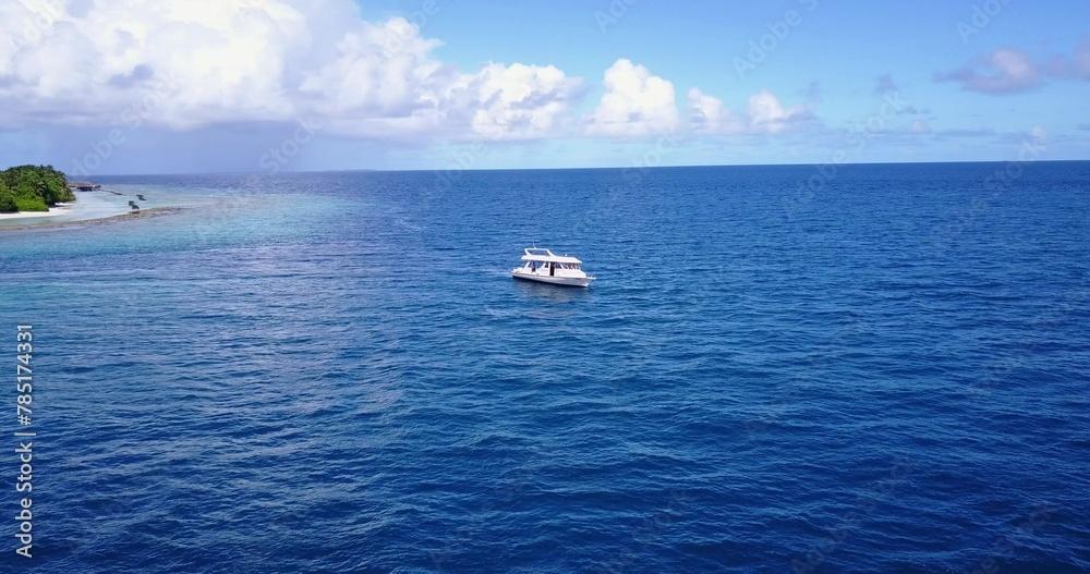 Aerial shot of a ship on a blue calm water