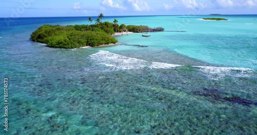 Aerial view of a small tropical island with a white sandy beach and turquoise water