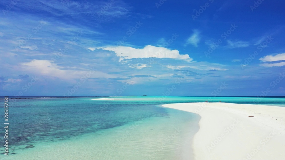 Beautiful shot of turquoise sea and white beach under cloudy sky in the Maldives Beautiful shot of turquoise sea and white beach under cloudy sky in the Maldives