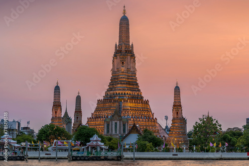 Wat Arun stupa  a significant landmark of Bangkok  Thailand  stands prominently along the Chao Phraya River  with a beautiful twilight.