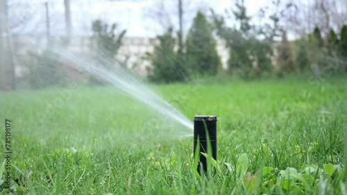 An automatic lawn watering system provides regular irrigation by directing streams of water over the entire surface of the lawn. photo