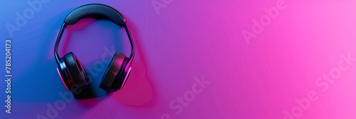 Stylish wireless headphones with ergonomic design against a gradient pink and blue background for contrast and appeal photo
