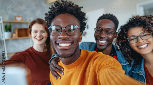 A group of multiethnic friends taking a selfie together, smiling and having fun in the office. © standret