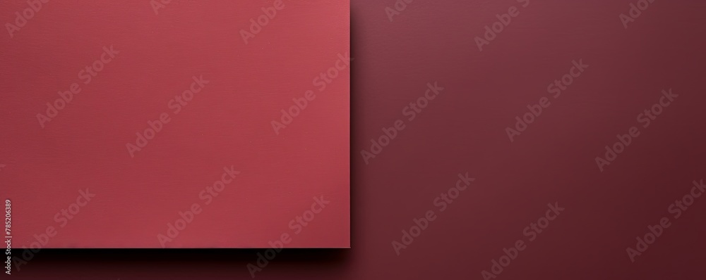 Maroon background with dark maroon paper on the right side, minimalistic background, copy space concept, top view, flat lay