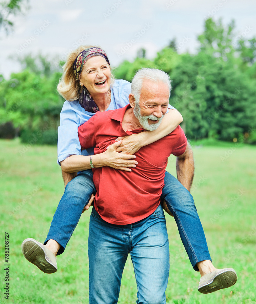 Fototapeta premium senior people couple happy elderly love together retirement man woman mature piggyback fun