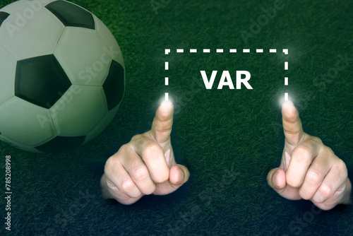 Soccer football referee hand show VAR symbol; Video assistant referee help referee decision in soccer game