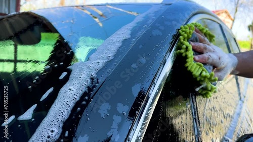 Man Washing A Black Car