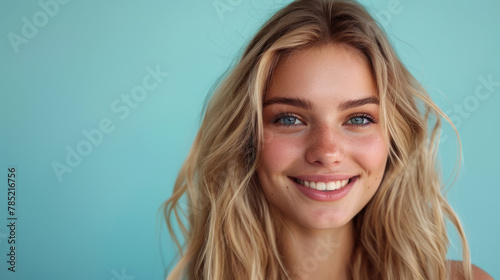 Blonde woman showcasing hair care products in a salon setting.