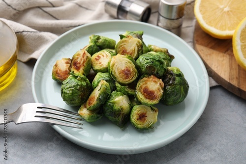 Delicious roasted Brussels sprouts on grey table, closeup