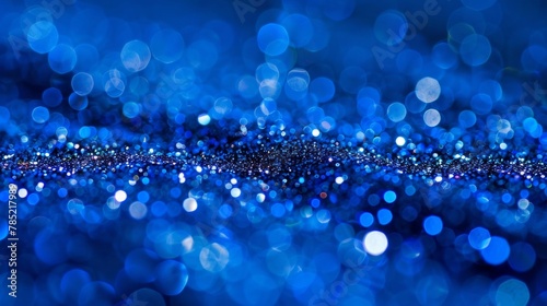Close-up of vivid blue bokeh lights, abstract and sparkling background.